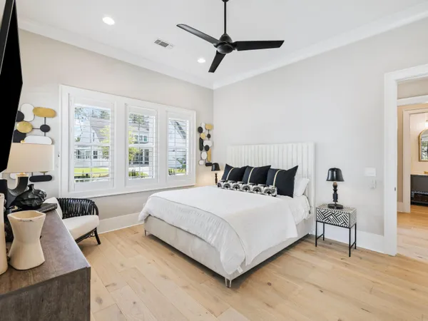 a bedroom with furniture and a large window
