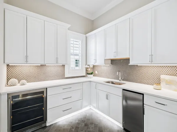 a kitchen with white cabinets and white appliances