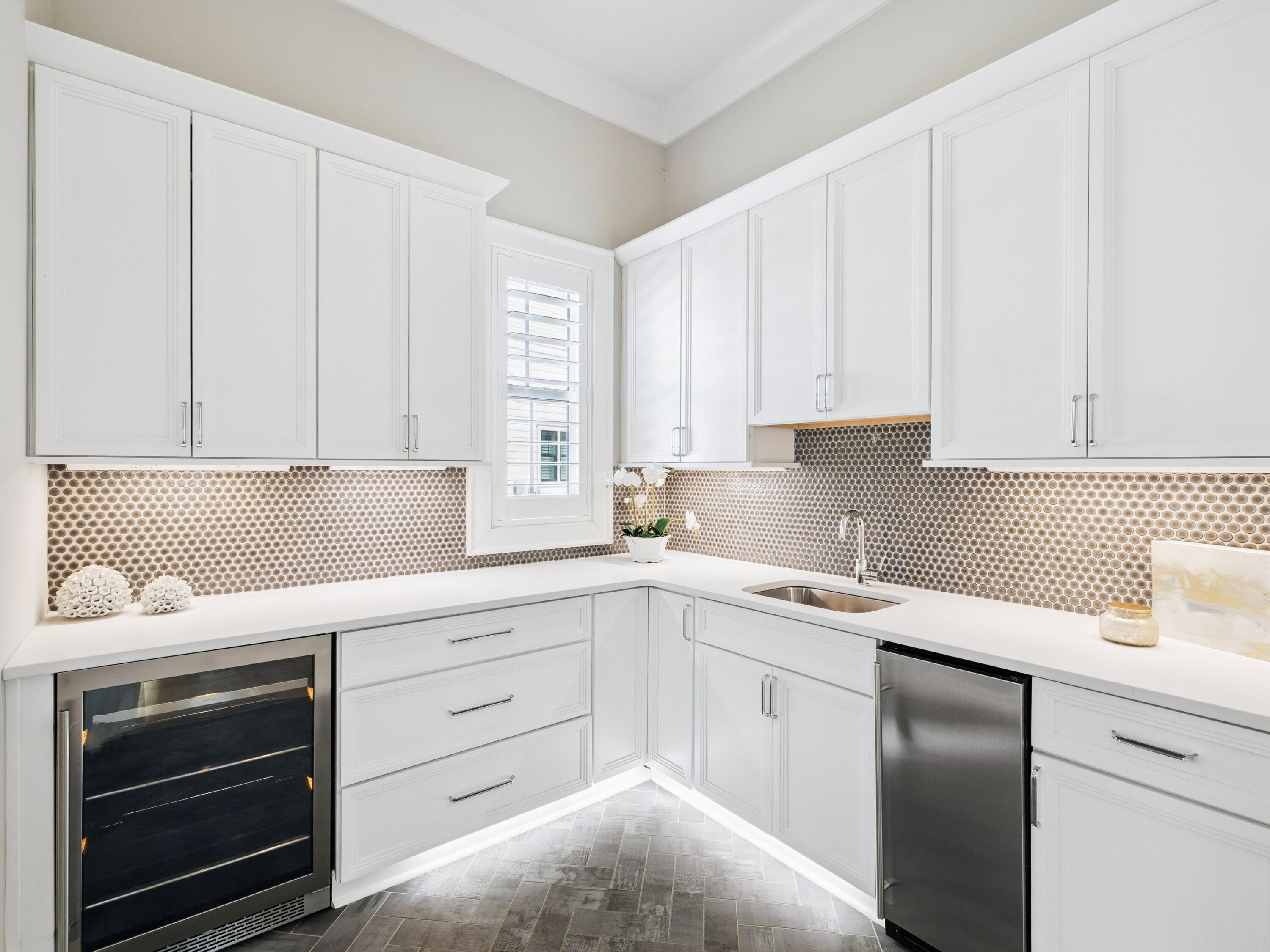85 Trailhead Drive Watersound, FL 32461 - Photo 17 of 48 a kitchen with white cabinets and white appliances