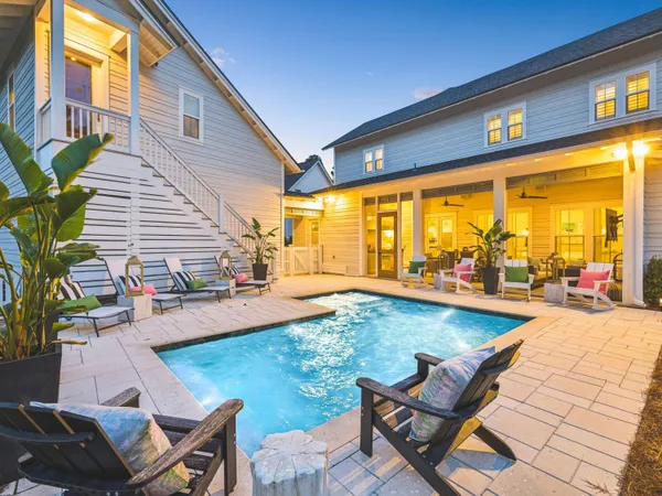 a view of a swimming pool with chairs in patio