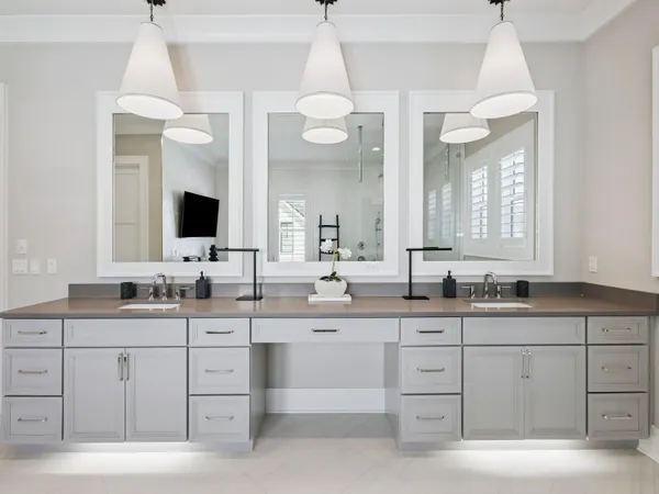 a spacious bathroom with a granite countertop sink a large mirror and a light fixture