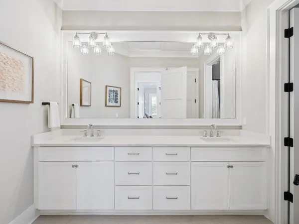 a bathroom with a double vanity sink mirror and
