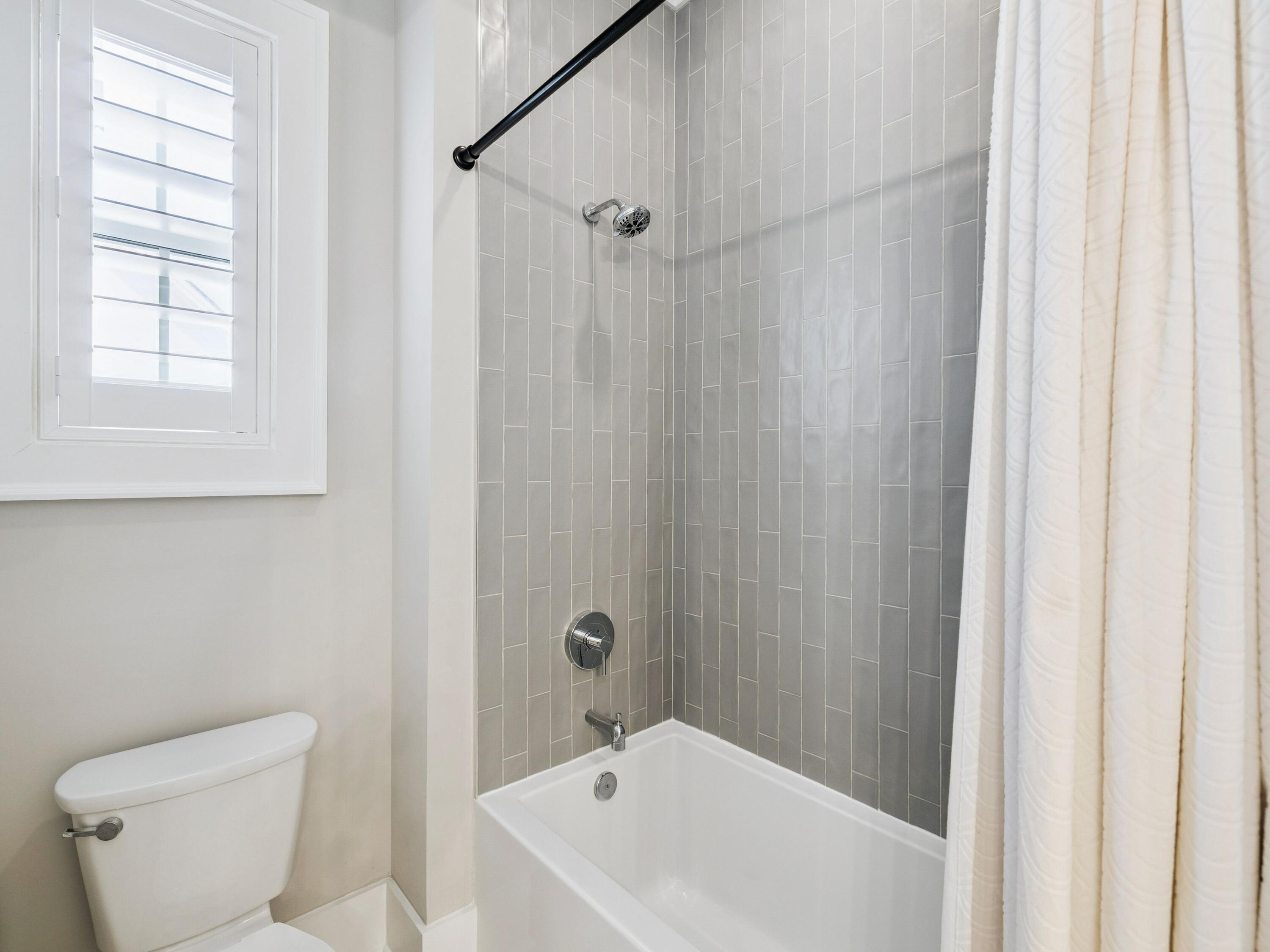85 Trailhead Drive Watersound, FL 32461 - Photo 31 of 48 a white bath tub sitting next to a white toilet and a shower