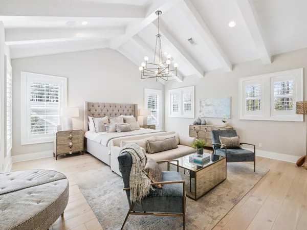 a bedroom with furniture and a chandelier