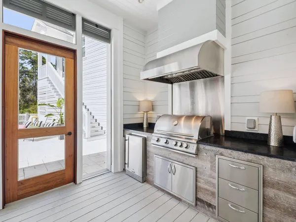 a kitchen with a stove a refrigerator and wooden floor