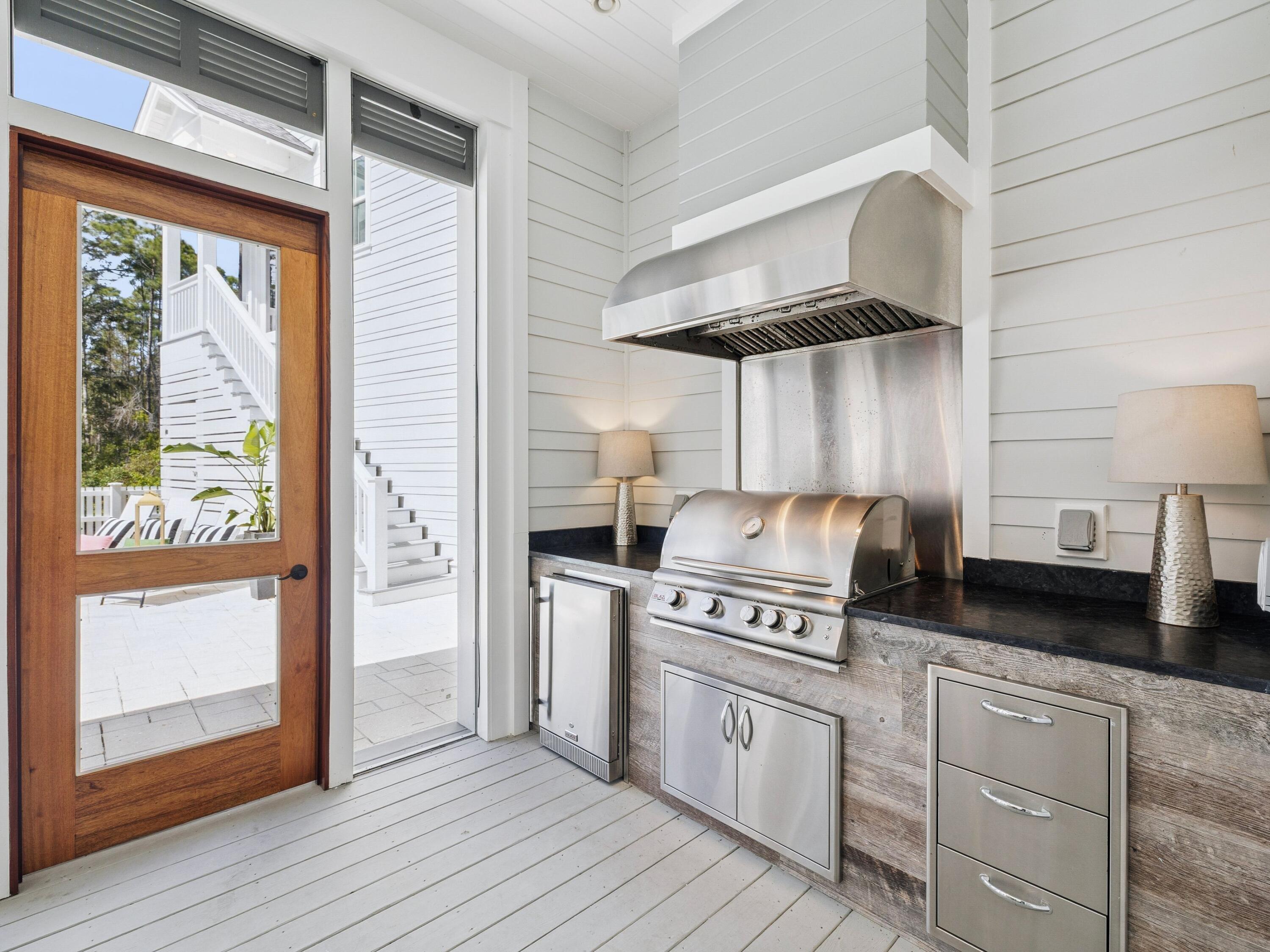 85 Trailhead Drive Watersound, FL 32461 - Photo 7 of 48 a kitchen with a stove a refrigerator and wooden floor
