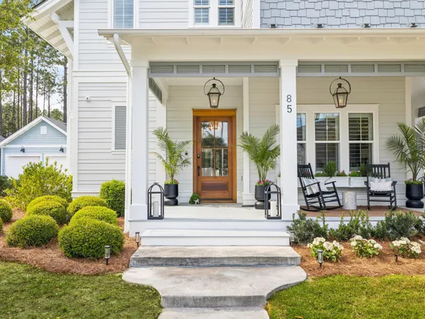 a front view of a house with potted plants