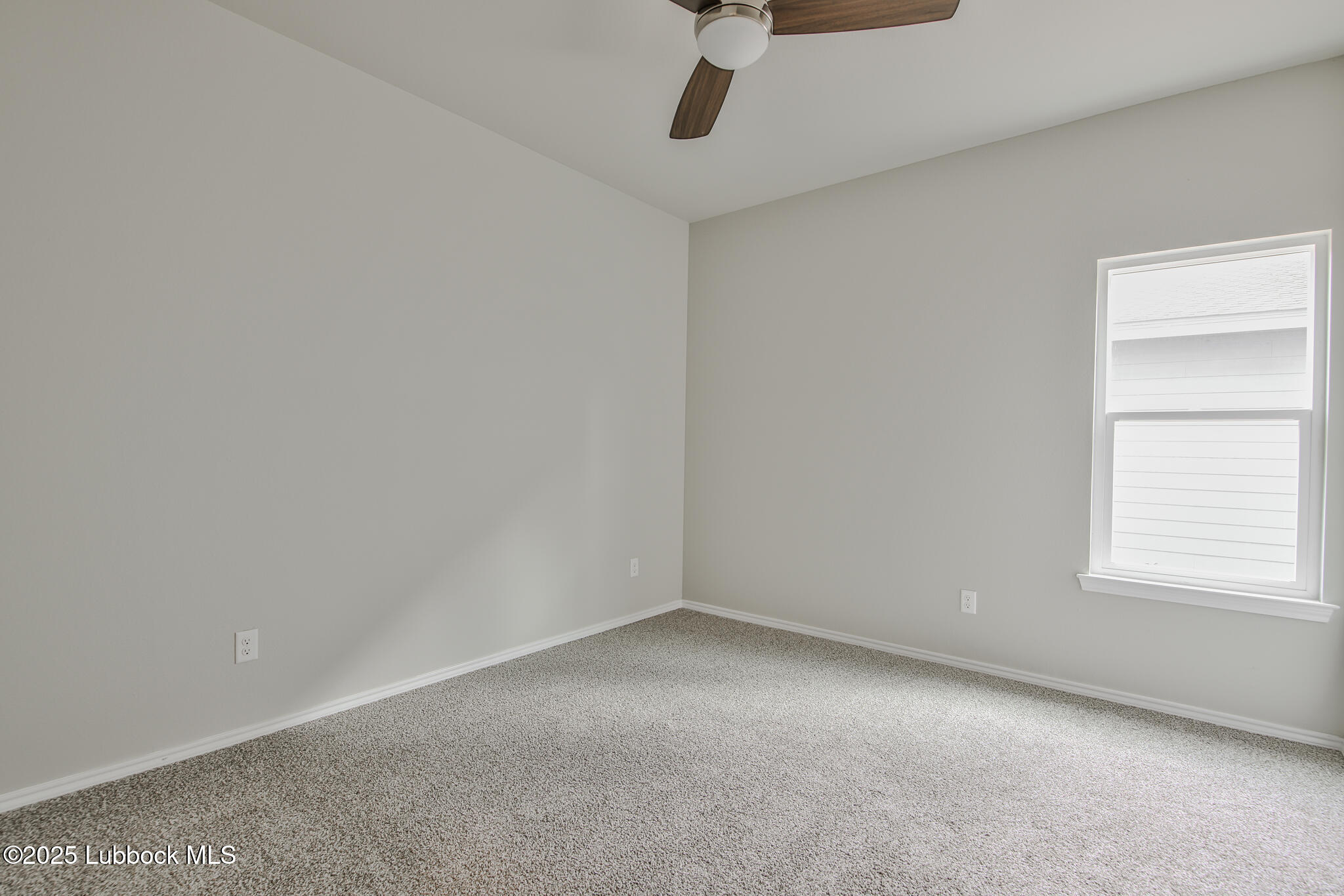 3121 74th Street Lubbock, TX 79423 - Photo 17 of 36 an empty room with a window