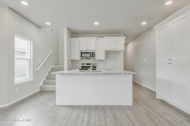 a view of kitchen with sink and wooden floor
