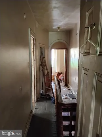a view of a hallway with workspace and living room