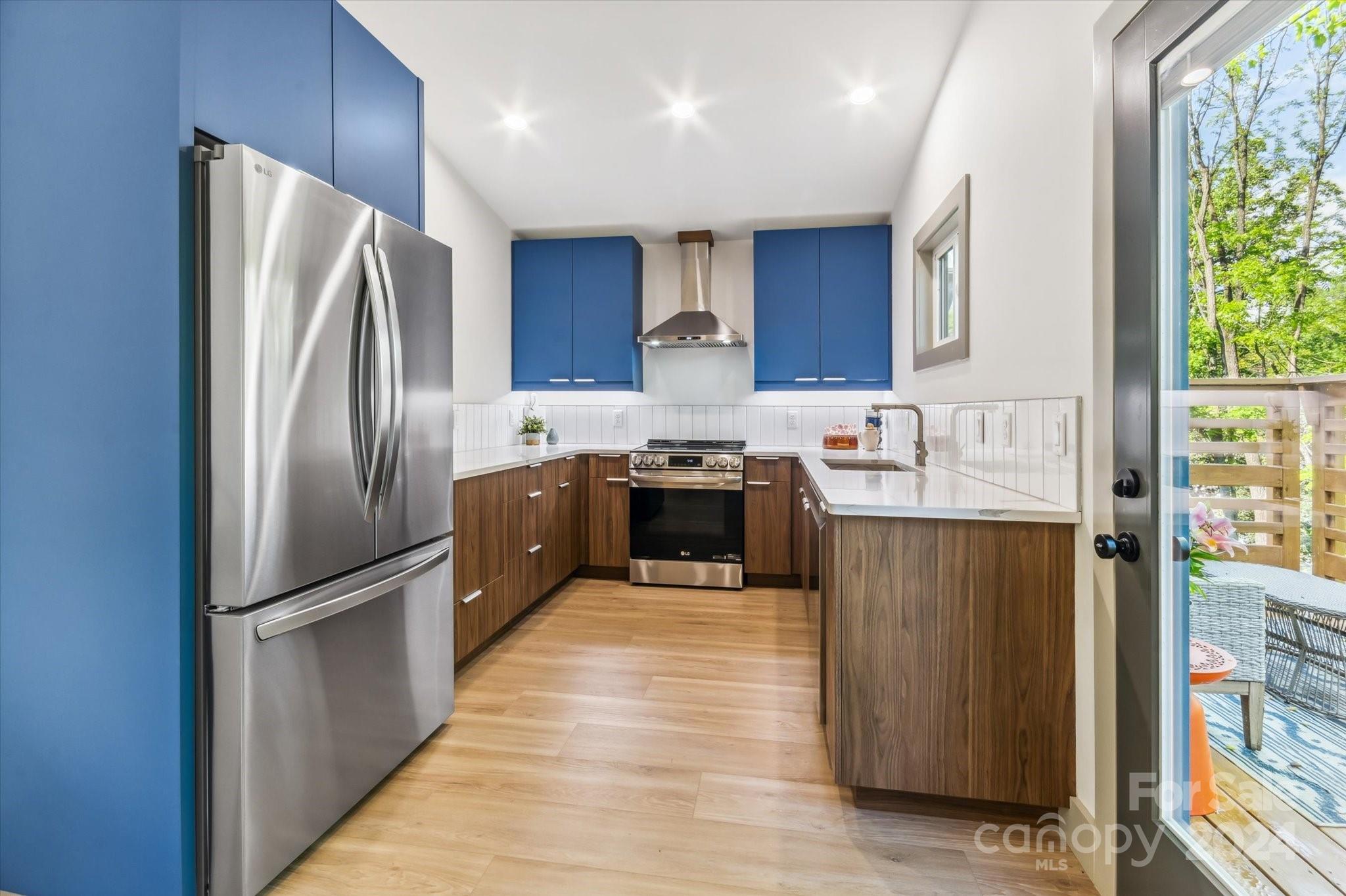 151 Laurel Loop Asheville, NC 28806 - Photo 11 of 35 a kitchen with stainless steel appliances granite countertop a refrigerator a sink a stove and oven