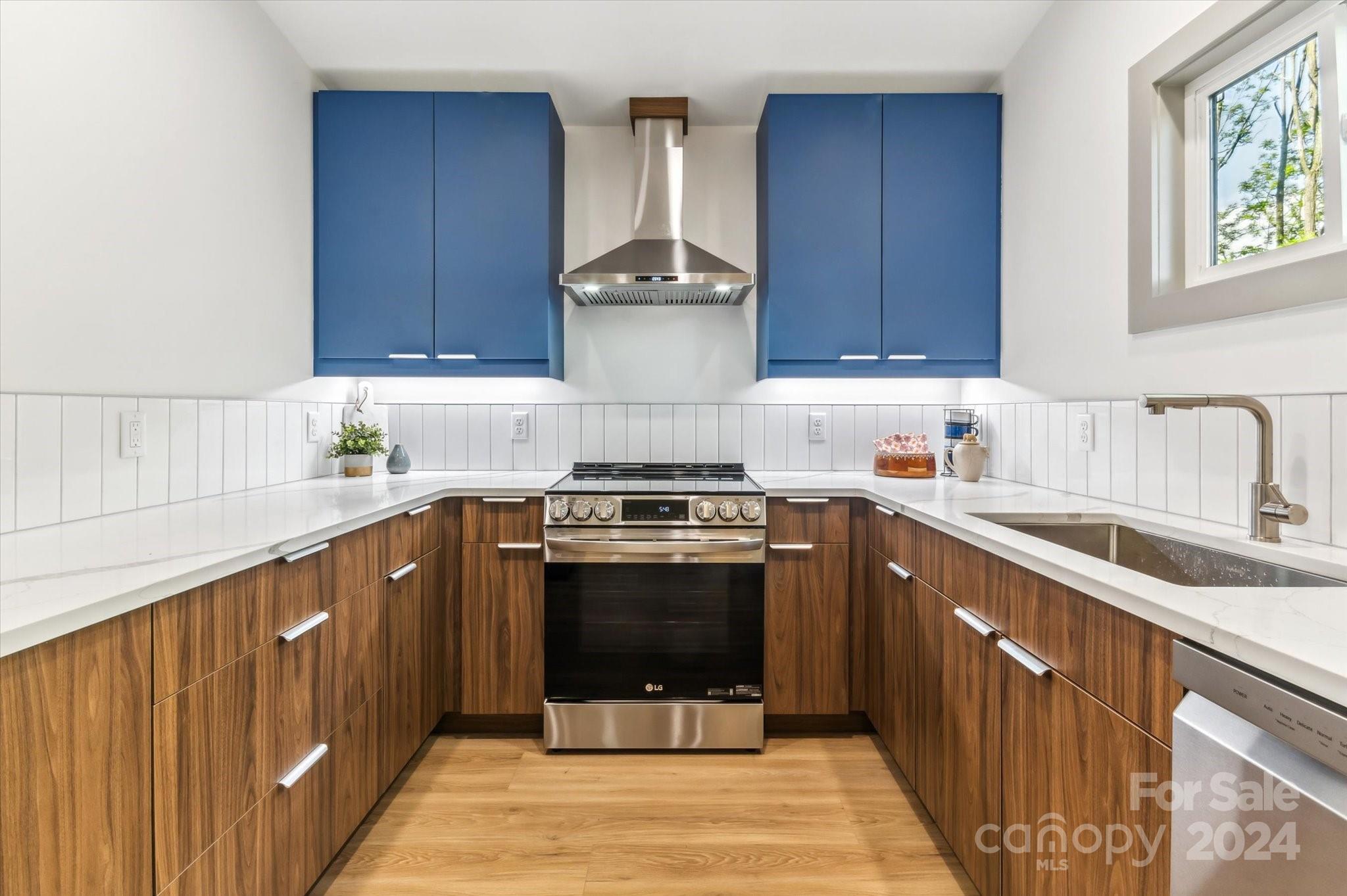 151 Laurel Loop Asheville, NC 28806 - Photo 12 of 35 a kitchen with a stove sink and cabinets