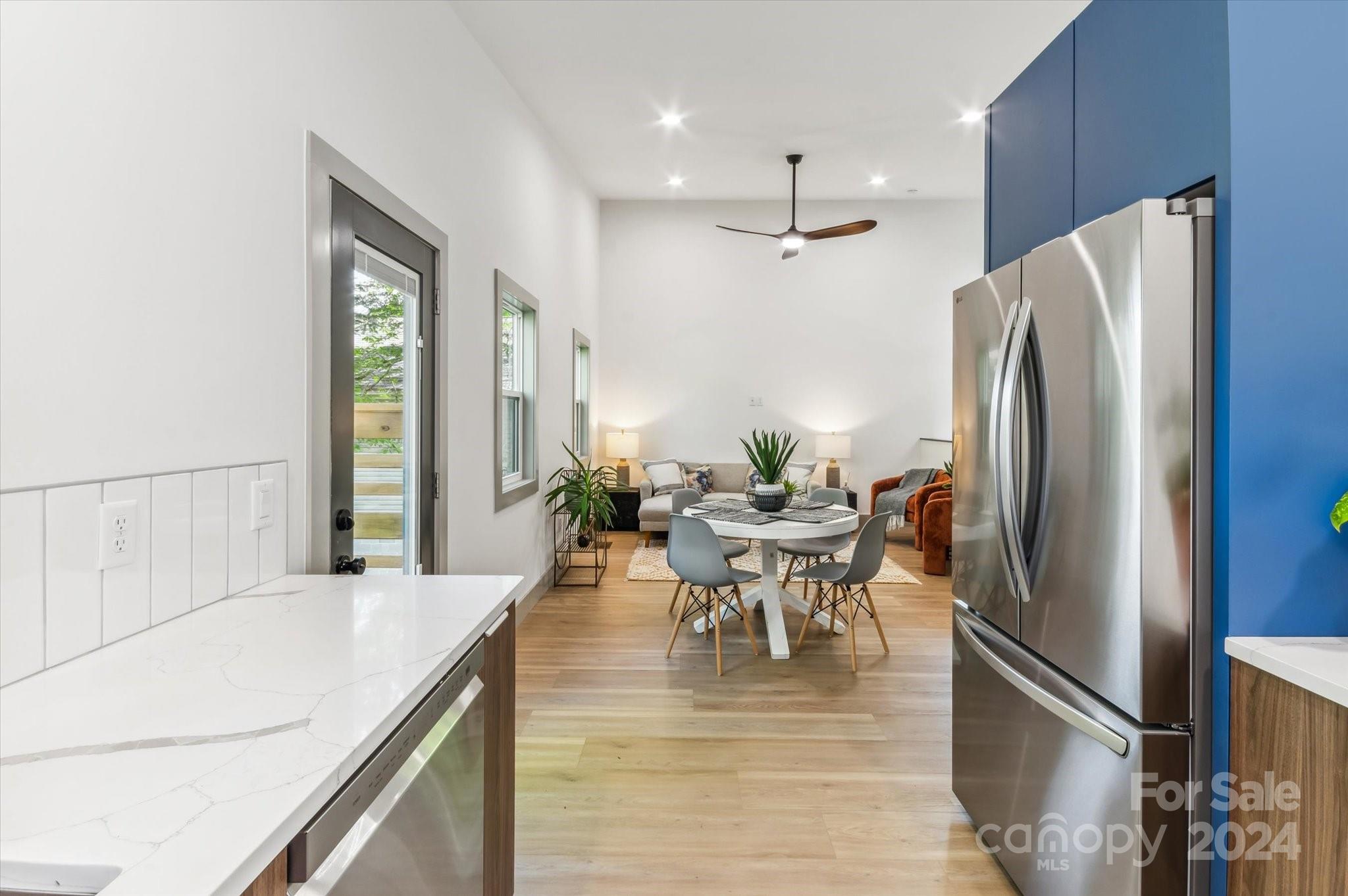 151 Laurel Loop Asheville, NC 28806 - Photo 13 of 35 a kitchen with stainless steel appliances refrigerator dining table and chairs