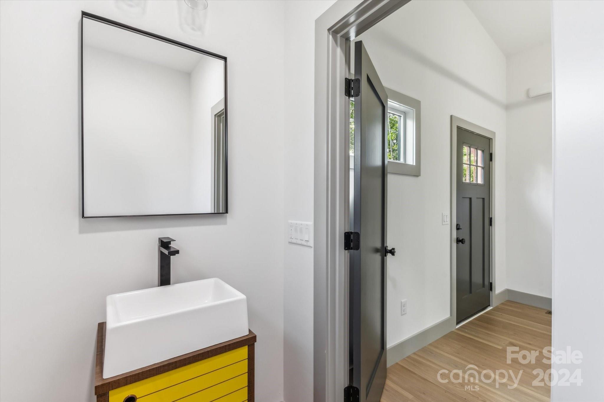 151 Laurel Loop Asheville, NC 28806 - Photo 20 of 35 a bathroom with a sink a mirror and shower