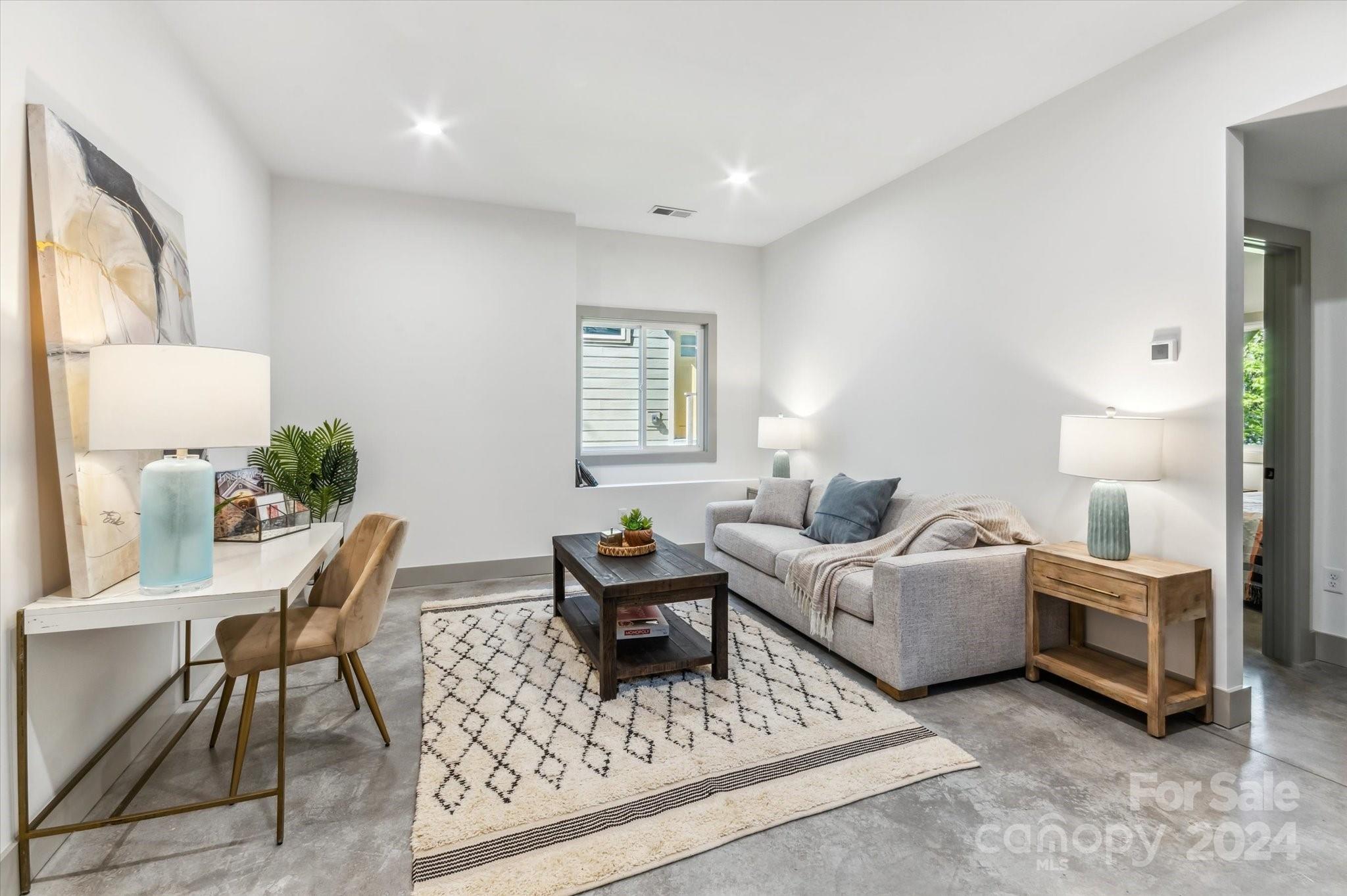 151 Laurel Loop Asheville, NC 28806 - Photo 22 of 35 a living room with furniture a bed and a lamp