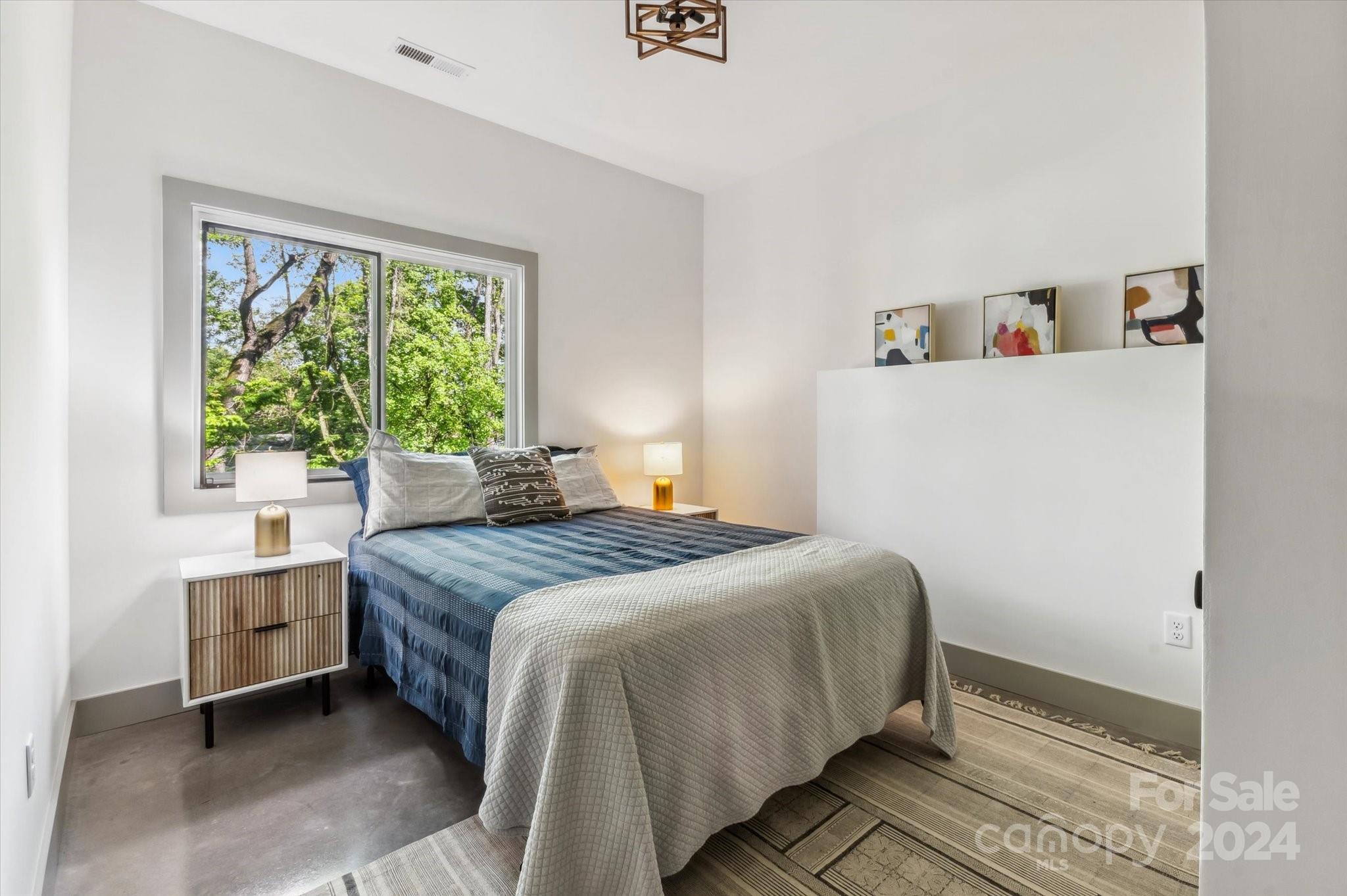 151 Laurel Loop Asheville, NC 28806 - Photo 26 of 35 a bedroom with a bed and a window