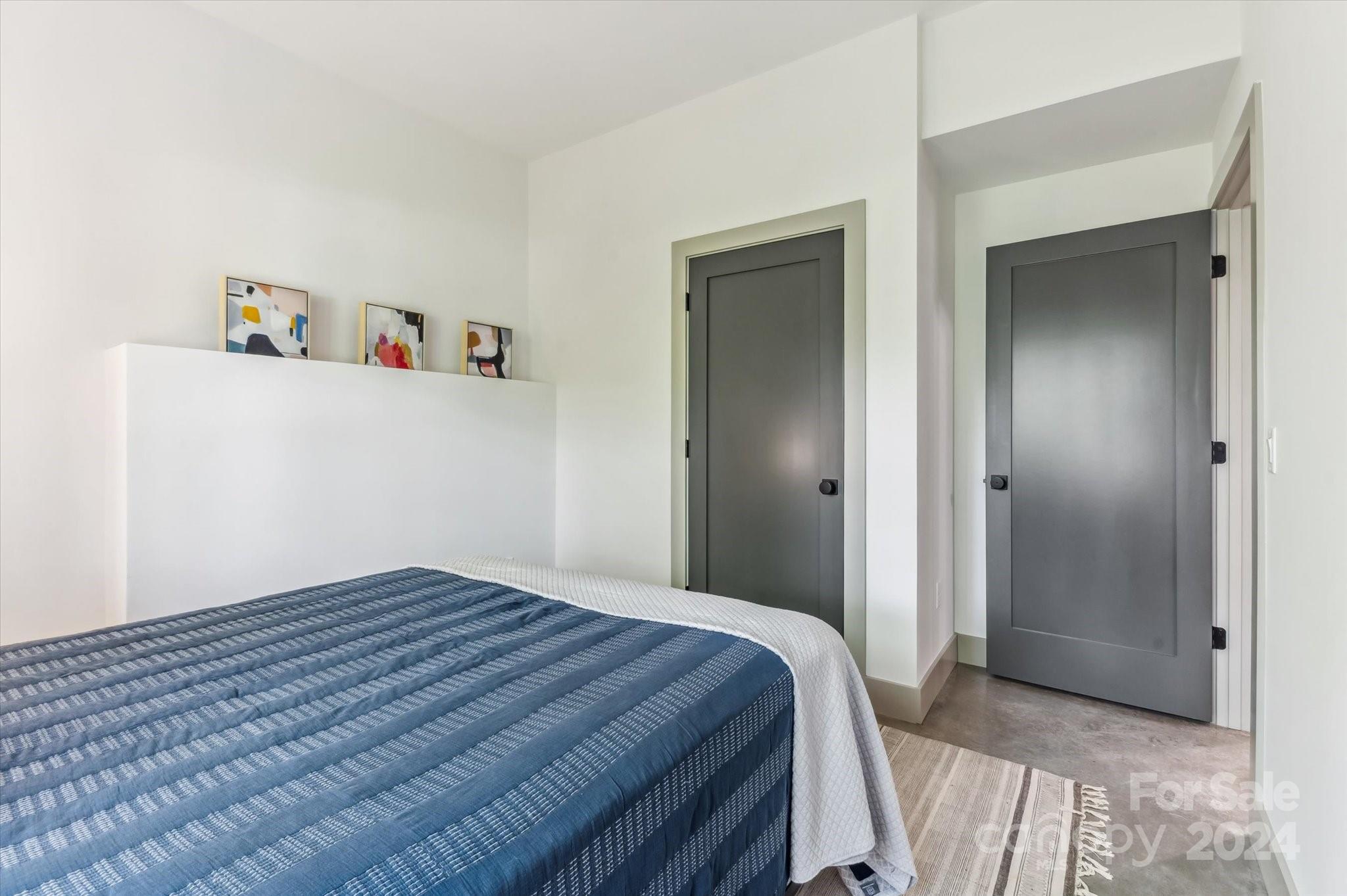 151 Laurel Loop Asheville, NC 28806 - Photo 27 of 35 a bedroom with a bed and a walk in closet