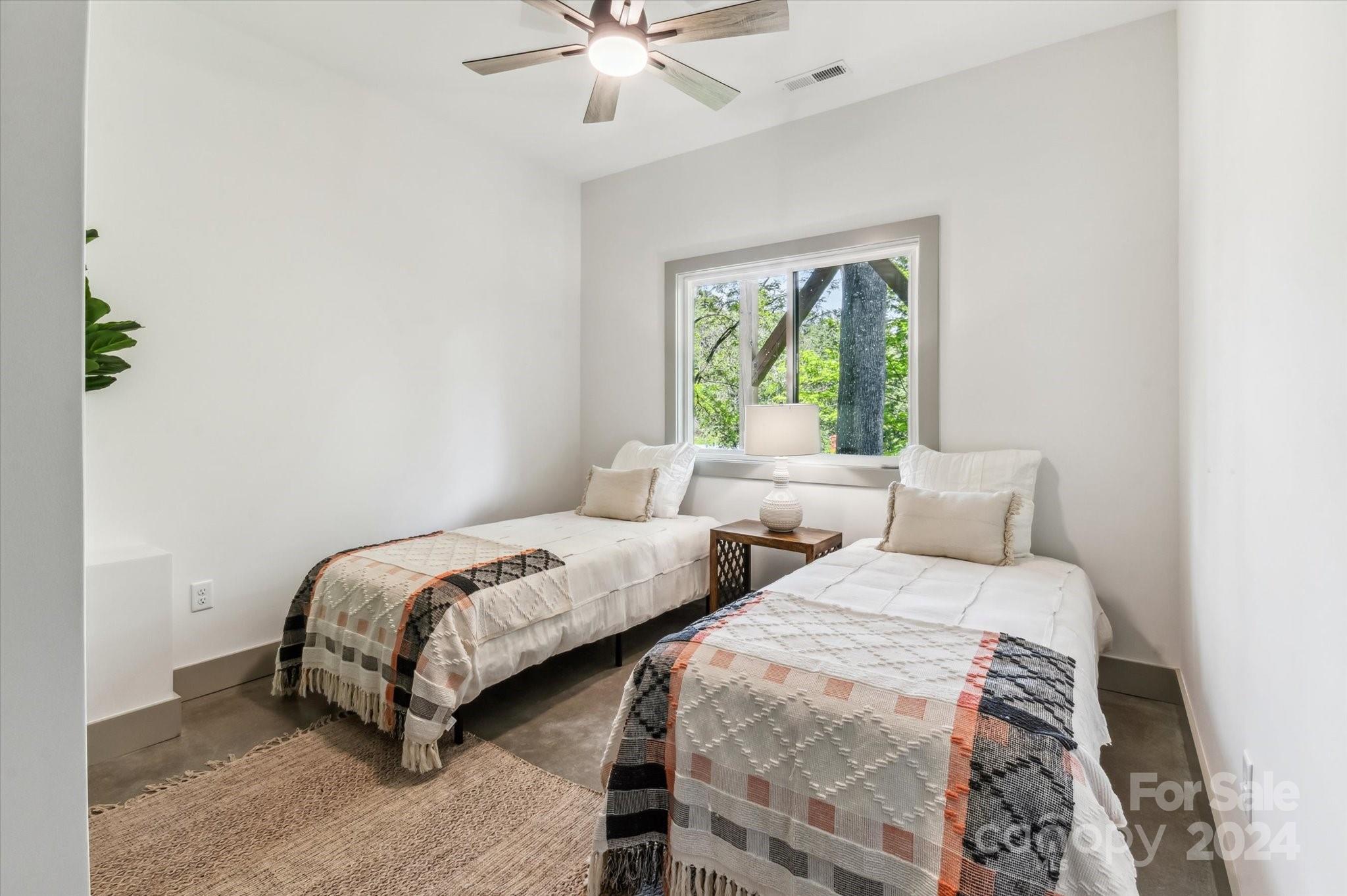 151 Laurel Loop Asheville, NC 28806 - Photo 28 of 35 a bedroom with two beds and a chandelier