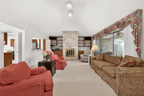 a living room with furniture fireplace and a flat screen tv
