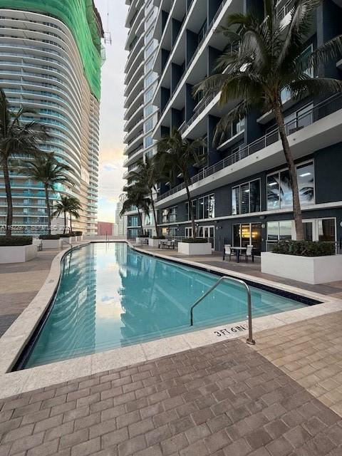 60 Southwest 13th Street, Unit 3620 Miami, FL 33130 - Photo 20 of 30 a view of a swimming pool with a lounge chair
