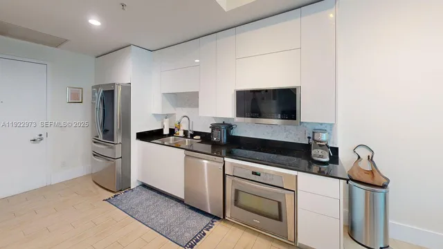 a kitchen with stainless steel appliances a refrigerator stove and sink