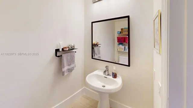 a bathroom with a sink and mirror