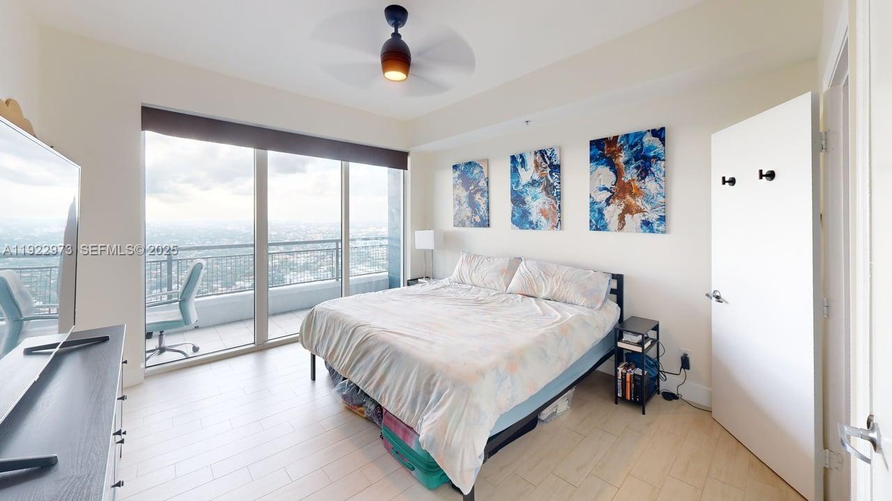 60 Southwest 13th Street, Unit 3620 Miami, FL 33130 - Photo 5 of 30 a bedroom with a large bed and a large window
