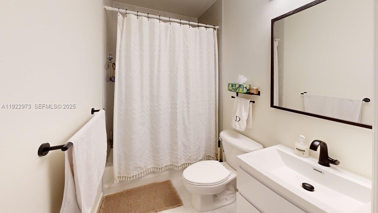 60 Southwest 13th Street, Unit 3620 Miami, FL 33130 - Photo 10 of 30 a bathroom with a sink toilet and shower