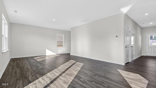 824 Comice Pear Way Willow Spring, NC 27592 - Photo 18 of 43 a view of an empty room and wooden floor
