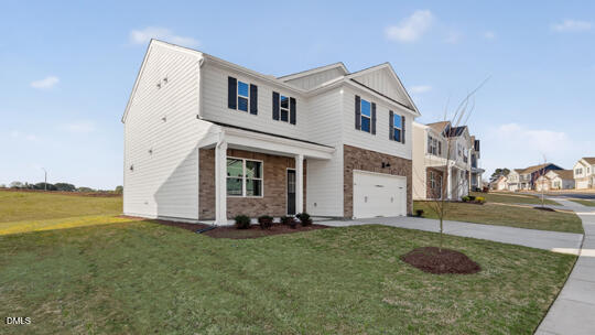824 Comice Pear Way Willow Spring, NC 27592 - Photo 2 of 43 a front view of a house with a yard