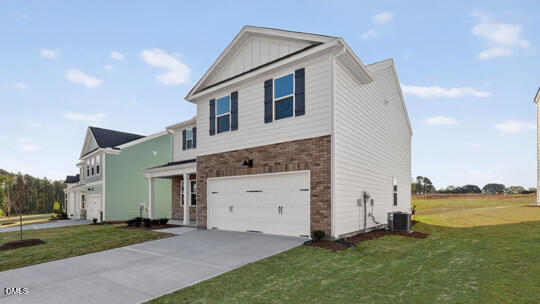 824 Comice Pear Way Willow Spring, NC 27592 - Photo 3 of 43 a front view of a house with a yard