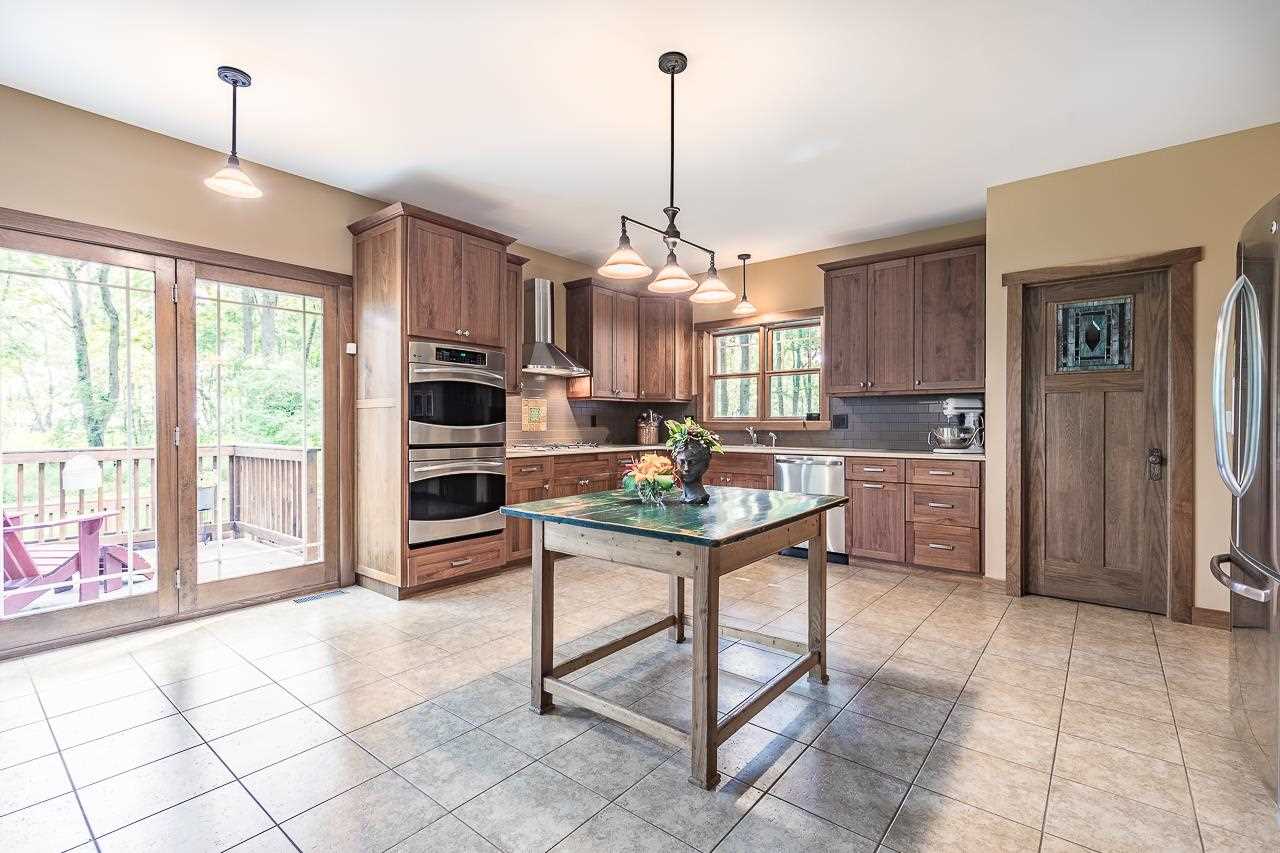 2595 Kendall Road Winnebago, IL 61088 - Photo 13 of 43 a kitchen with kitchen island granite countertop a stove a sink and a refrigerator