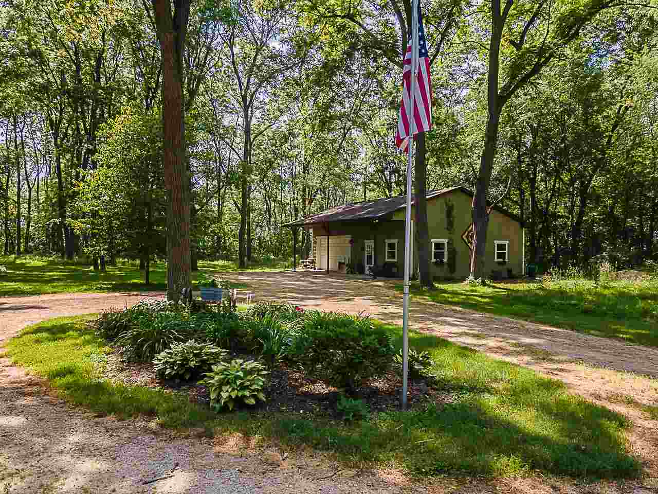 2595 Kendall Road Winnebago, IL 61088 - Photo 33 of 43 a view of a house with backyard and a tree
