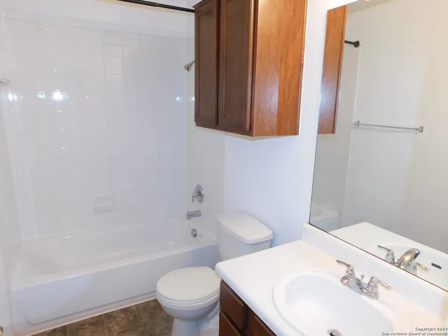 a bathroom with a sink toilet vanity and shower
