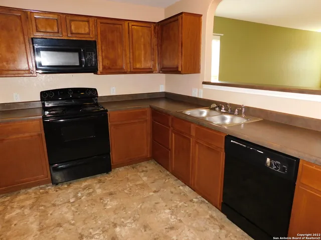 a kitchen with a sink stove and microwave