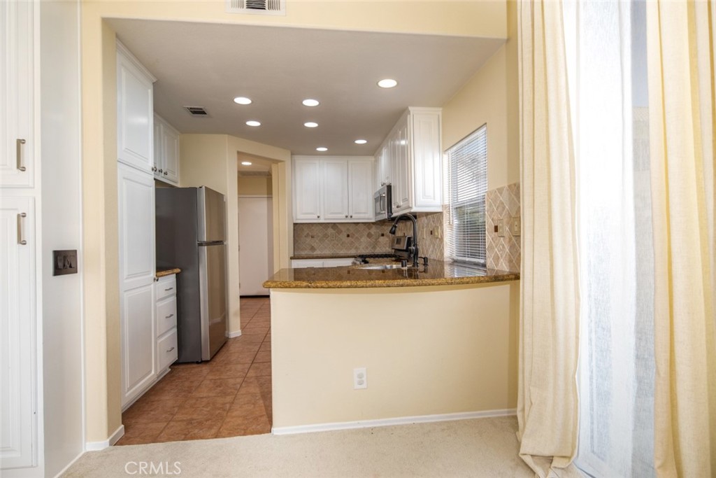 1 Quebec Aliso Viejo, CA 92656 - Photo 7 of 40 a kitchen with stainless steel appliances granite countertop a refrigerator and a stove