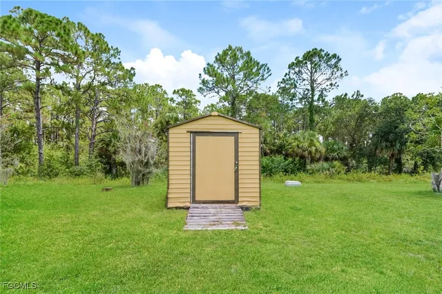a backyard of a house with table and chairs