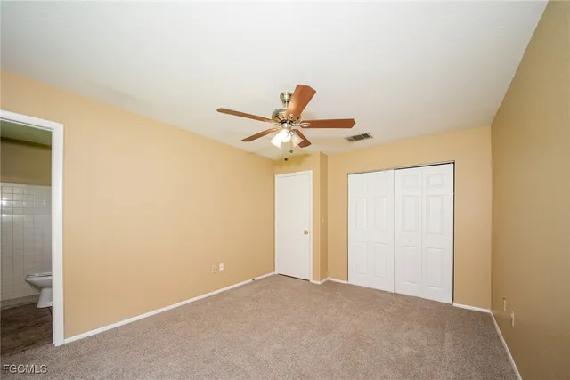 a view of a hallway with a ceiling fan