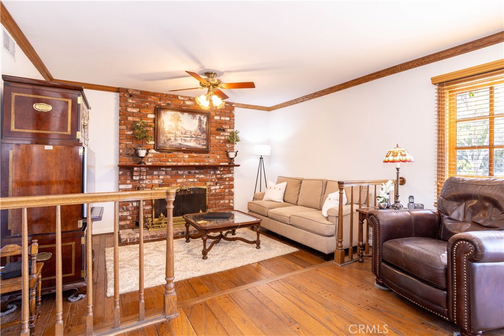 18924 Granada Circle Porter Ranch, CA 91326 - Photo 16 of 45 a living room with furniture a flat screen tv and a floor to ceiling window