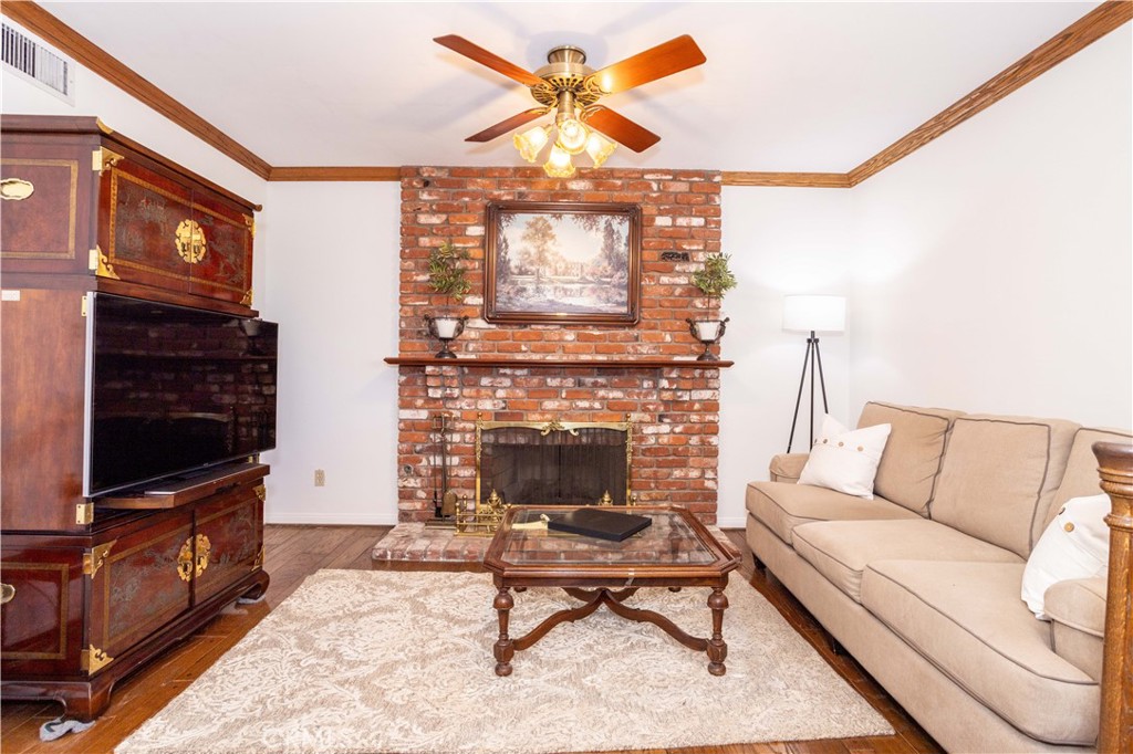 18924 Granada Circle Porter Ranch, CA 91326 - Photo 17 of 45 a living room with furniture a flat screen tv and a fireplace