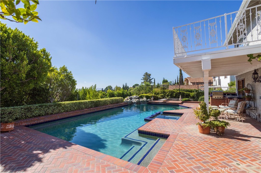 18924 Granada Circle Porter Ranch, CA 91326 - Photo 34 of 45 a view of a swimming pool with a patio