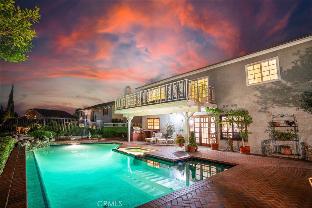 18924 Granada Circle Porter Ranch, CA 91326 - Photo 39 of 45 a front view of a house with swimming pool garden and patio