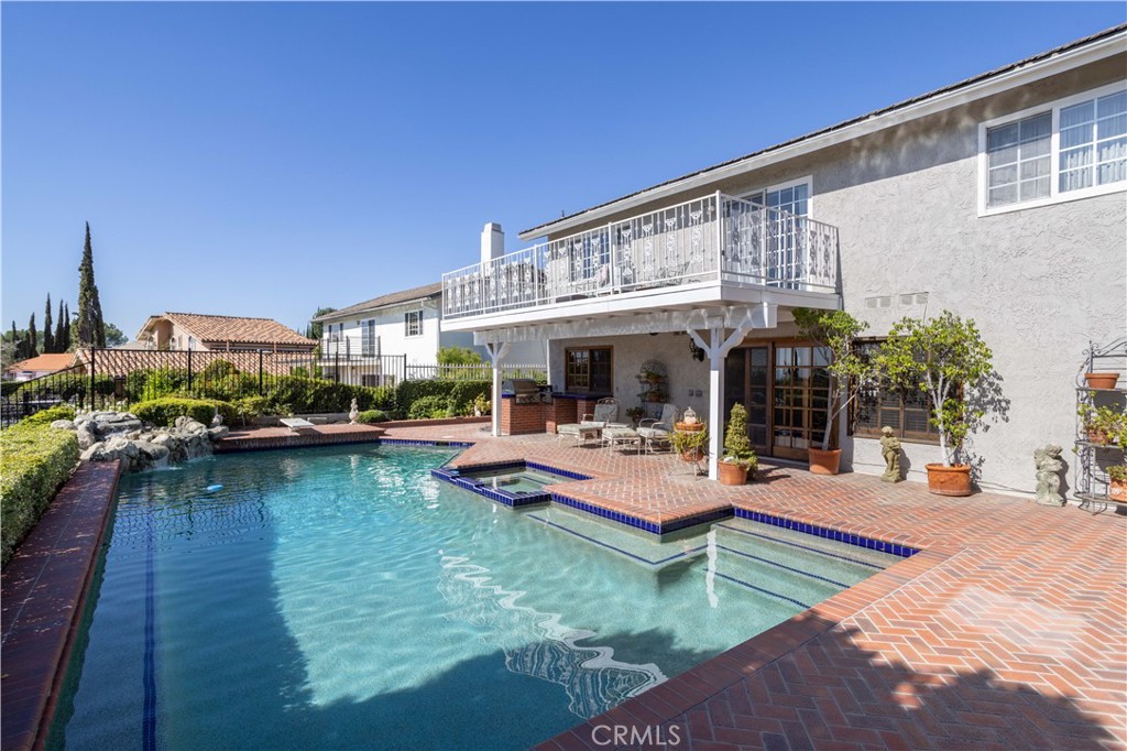 18924 Granada Circle Porter Ranch, CA 91326 - Photo 40 of 45 a view of a swimming pool with chairs in patio