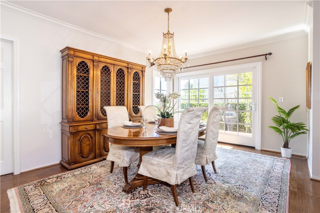 18924 Granada Circle Porter Ranch, CA 91326 - Photo 8 of 45 a dining room with furniture wooden floor a chandelier and a rug