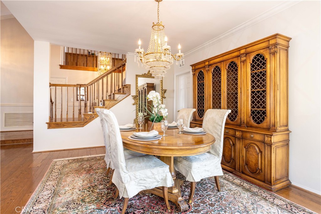 18924 Granada Circle Porter Ranch, CA 91326 - Photo 9 of 45 a dining room with furniture a chandelier and wooden floor