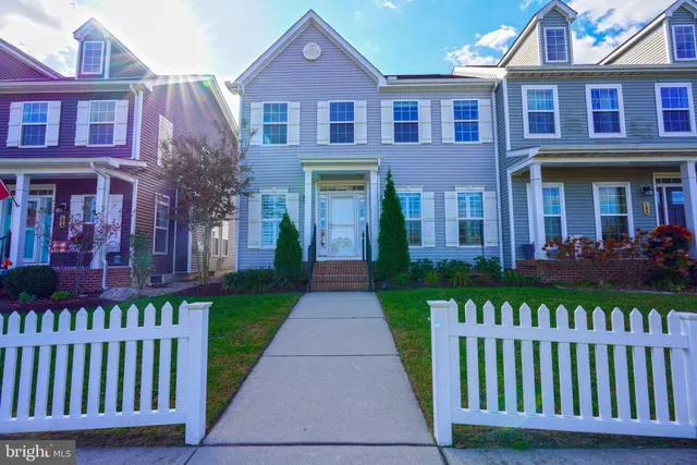a front view of a brick house with a yard