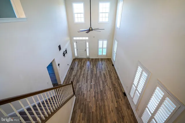 a view of a hallway view with wooden floor and staircase