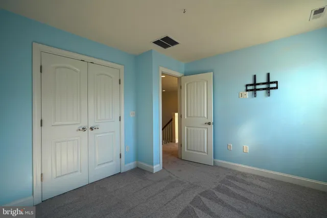 an empty room with closet and a bathroom