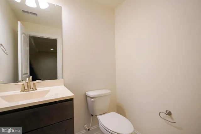 a bathroom with a sink a toilet and mirror