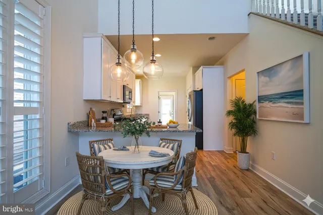 a view of a dining room with furniture and a chandelier